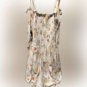 Stylish floral romper with tie back.